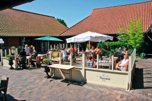 un groupe de personnes assises dans un restaurant en plein air dans l'établissement Kustpark Strand Westende, à Middelkerke