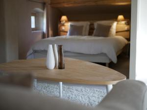 グロスピエールにあるLes agavesのベッド2台、テーブル、ベッド2台が備わる客室です。