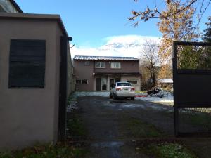 a car parked in front of a house with a snow covered mountain at Departamento Meliades in El Bolsón +4 photos