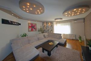 a living room with a couch and a table at Franstal Apartments in Belgrade