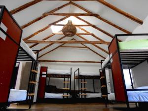 a room with four bunk beds and a ceiling at Intro Hostels Cusco in Cusco