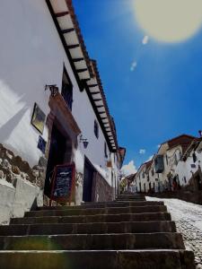 a staircase leading up to a building with snow on the ground at Intro Hostels Cusco in Cusco