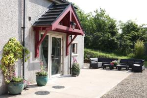 a patio with a red awning on a building at Cuilcagh Luxury Studio in Enniskillen