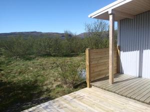 a wooden porch on a house with a view of a field at Hagi 2 Road 62 nr 1 in Hagi