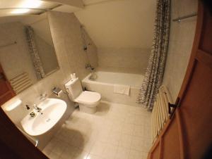 a bathroom with a sink and a toilet and a tub at Hotel Gabriela in Vítkovice