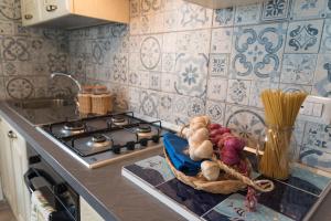 a kitchen counter with a basket of vegetables on it at Casa brillocco Castellabate in Montecorice +33 photos