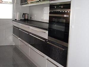 a kitchen with two black ovens in a kitchen at Seefelder Urlaubsparadies in Seefeld