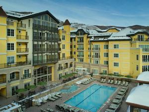 a view of a hotel with a swimming pool at The Vail Collection at the Ritz Carlton Residences Vail in Vail