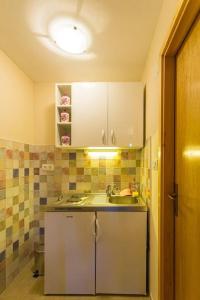 a small kitchen with a sink and a counter at Fresh & spacious studio in Dubrovnik