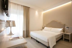 a hotel room with a bed and a window at Hotel Grottamare in Lido di Jesolo +42 photos