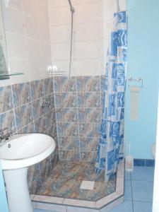 a bathroom with a shower with a toilet and a sink at Ozola street apartment in Ventspils