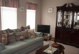 a living room with a couch and a tv at Eagle View Holiday Home in Moone