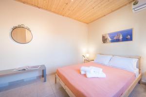 a bedroom with a bed with a desk and a mirror at Amygdalia Villa with Private Pool, by ZanteWize in Pandokrátor