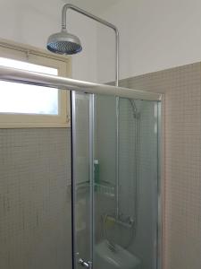 a bathroom with a shower with a glass door at Casa do Jardim (Garden House) in Vila do Conde