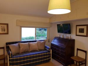 a living room with a couch and a flat screen tv at Casa do Jardim (Garden House) in Vila do Conde