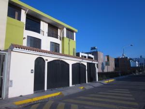 a building with gates on the side of a street at Challapampa Apart Arequipa in Arequipa