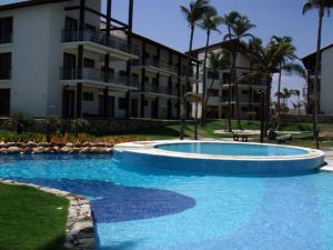Villa 06 - Taiba Beach Resort - TBR في São Gonçalo do Amarante: مسبح كبير امام مبنى