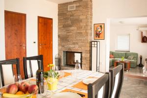 a dining room with a table and a fireplace at Lukovo Seafront Apartments in Lukovo