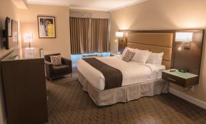 a hotel room with two beds and a television at MStar Hotel in Kitimat