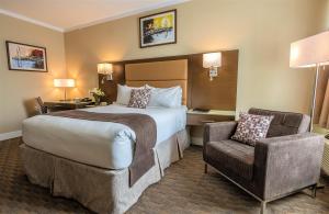 a hotel room with two beds and two lamps at MStar Hotel in Kitimat