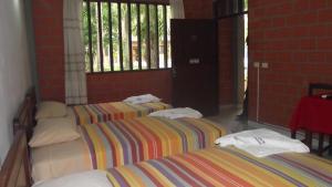 Postel nebo postele na pokoji v ubytování Hotel Ambaibo