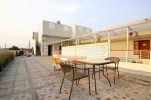 a patio with a table and chairs on a building at RedDoorz Plus near UPN Jogjakarta 2 in Yogyakarta