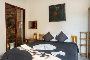a bedroom with a bed with two towels on it at Hue River Side Villa in Hue