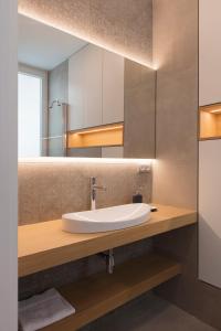 a bathroom with a sink and a mirror at FLORIT FLATS - Chic and Central in a lively but quiet area All walking distance in Valencia +38 photos