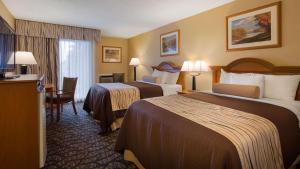 a hotel room with two beds and a desk at Best Western Clifton Park in Clifton Park