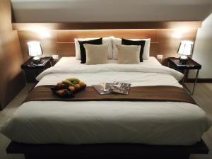 a large bed with a tray of fruit on it at M.I.N.D. Villa in Chiang Mai