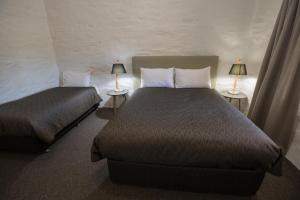 Ένα ή περισσότερα κρεβάτια σε δωμάτιο στο Paxton Square Cottages