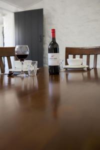 a table topped with glasses and a wine glass at Paxton Square Cottages in Burra