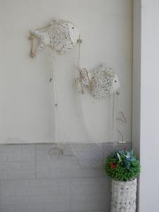 a white dress hanging on a wall in a bathroom at B&B Giorgio La Pira in Santa Maria del Focallo