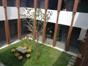 an overhead view of a courtyard with a tree and tables at M.I.N.D. Villa in Chiang Mai