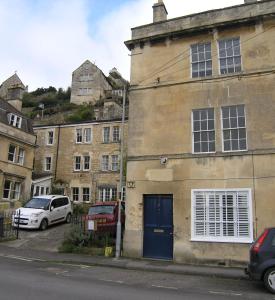 a building with a blue door on the side of a street at 38 Newtown in Bradford on Avon