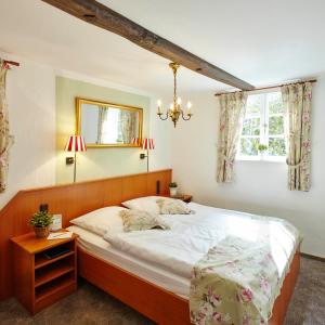 a bedroom with a large bed and a window at Landhaus Haverbeckhof in Niederhaverbeck