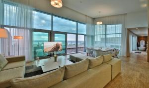 a living room with a large couch and a table at Flamingo Grand Hotel & Spa in Albena
