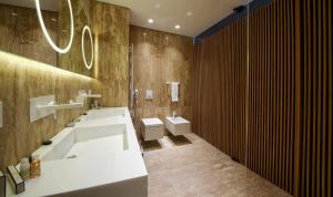 a bathroom with two sinks and two toilets at Flamingo Grand Hotel & Spa in Albena
