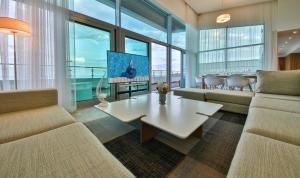 a living room with a couch and a table at Flamingo Grand Hotel & Spa in Albena