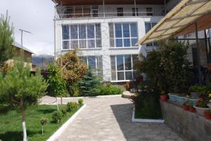 a house with a garden in front of it at Panorama in Cholpon-Ata