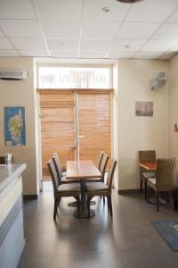 a dining room with a table and chairs and a window at Hotel du Palais in Ajaccio