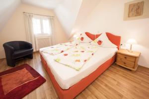 a bedroom with a large bed and a chair at Alter Posthof Ferienwohnungen in Bernkastel-Kues