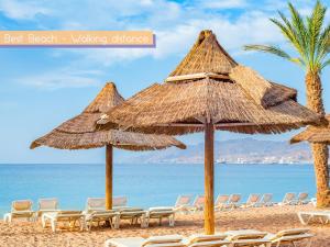 un gruppo di sedie e ombrelloni in spiaggia di FaRoyal Luxury Suite a Eilat