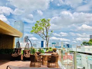 a balcony with a table and chairs and a city skyline at Adora Hotel in Ho Chi Minh City