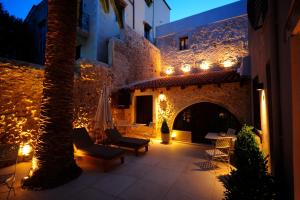 a room with a table and a fire place in it at Pepi Boutique Hotel (Adults Only) in Rethymno