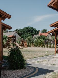 a park with a playground with a slide at Domek Piotr 2 in Stegna