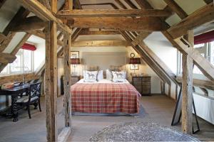 a attic bedroom with a bed and a desk at Wingrove House in Alfriston