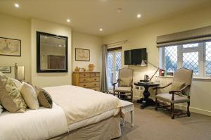 - une chambre avec un lit, un bureau et une table dans l'établissement Wingrove House, à Alfriston