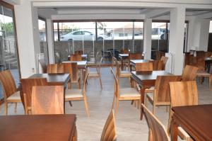 a dining room with wooden tables and chairs at Longoz Hotel in Igneada