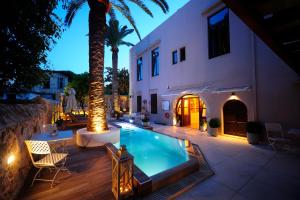 a backyard with a swimming pool and a house at Pepi Boutique Hotel (Adults Only) in Rethymno Town